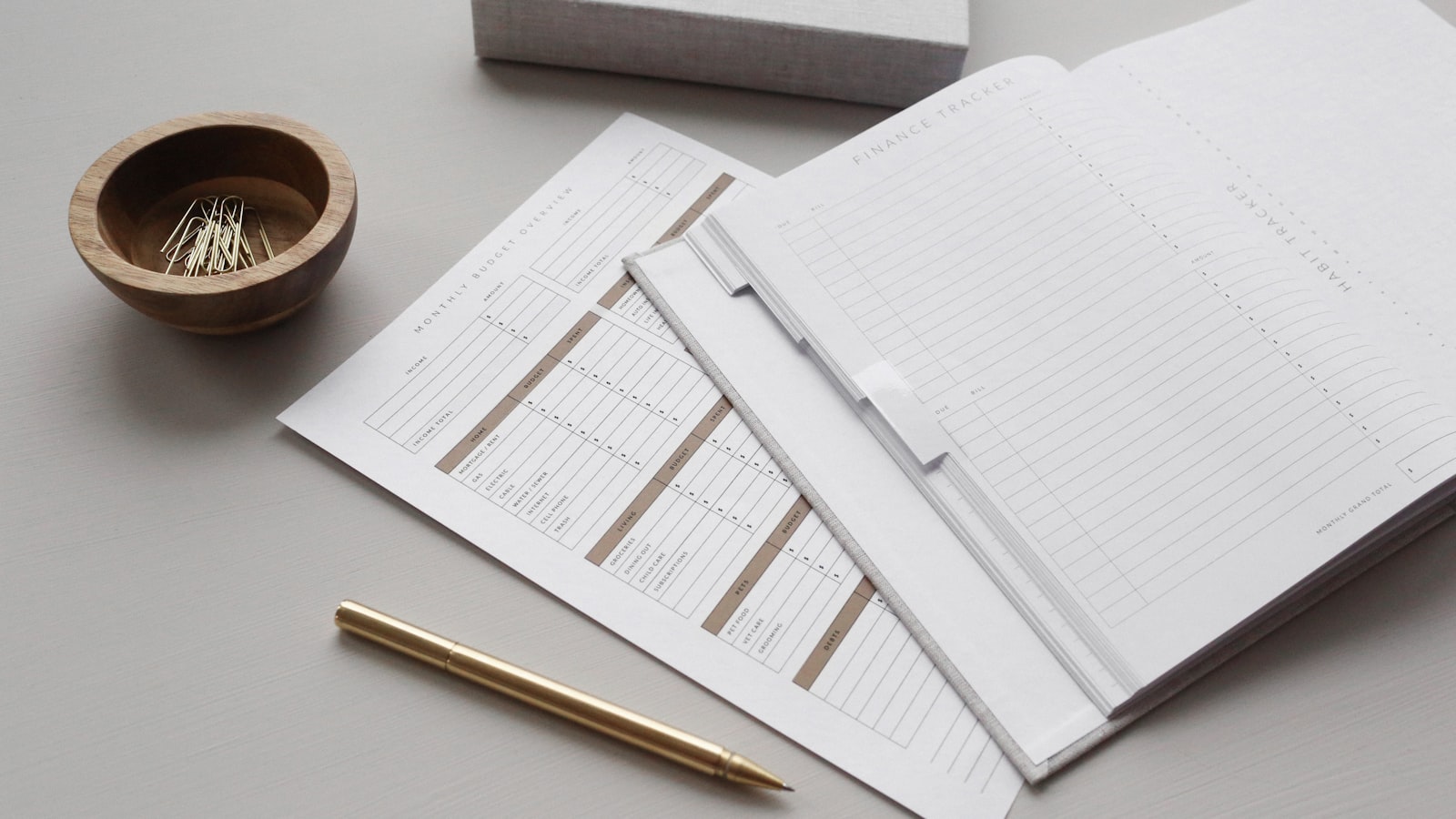 Budget planner with sheets and a gold pen