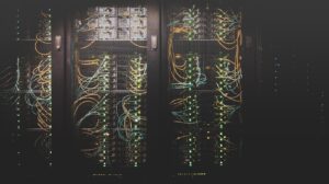 Server racks and network cables in a data center, representing tech's carbon footprint